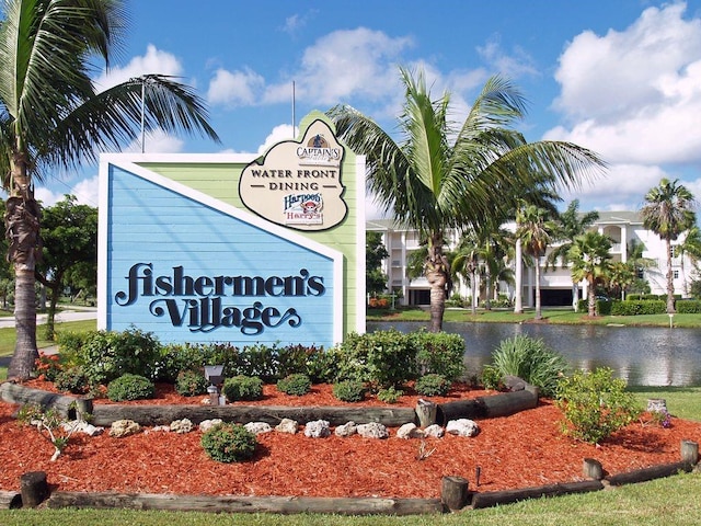 community sign with a water view