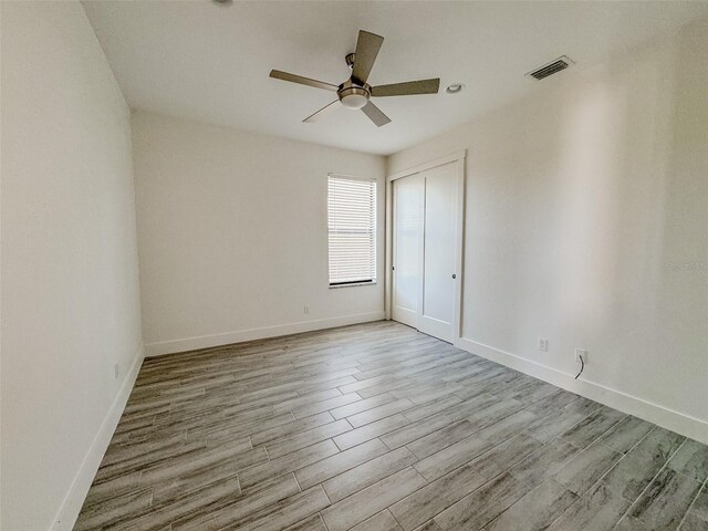 unfurnished room featuring ceiling fan and light hardwood / wood-style floors