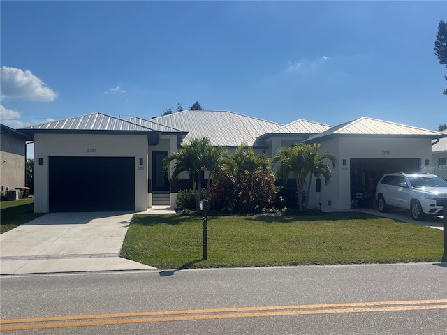 2709 Magdalina Dr Unit 101 102B, Punta Gorda, FL 33950 - ranch-style home featuring concrete driveway, stucco siding, a front lawn, a garage, and metal roof