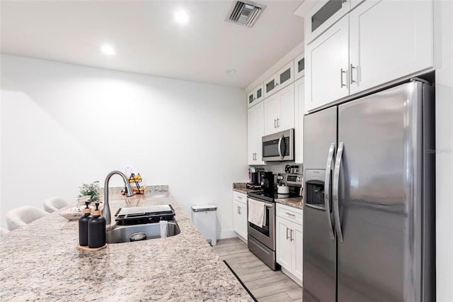 2709 Magdalina Dr Unit 101 102B, Punta Gorda, FL 33950 - kitchen with white cabinets, appliances with stainless steel finishes, a sink, and visible vents