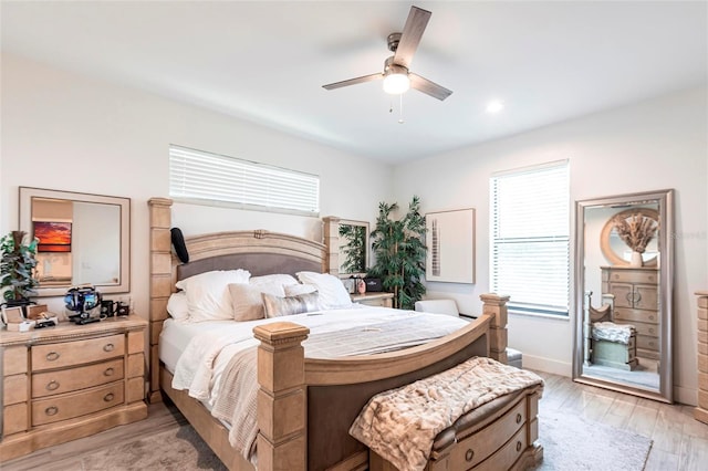 2709 Magdalina Dr Unit 101 102B, Punta Gorda, FL 33950 - bedroom featuring ceiling fan, multiple windows, baseboards, and light wood finished floors