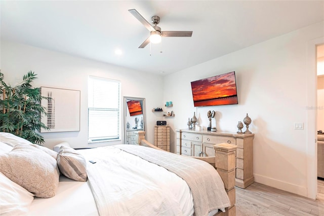 2709 Magdalina Dr Unit 101 102B, Punta Gorda, FL 33950 - bedroom with baseboards, light wood finished floors, and a ceiling fan