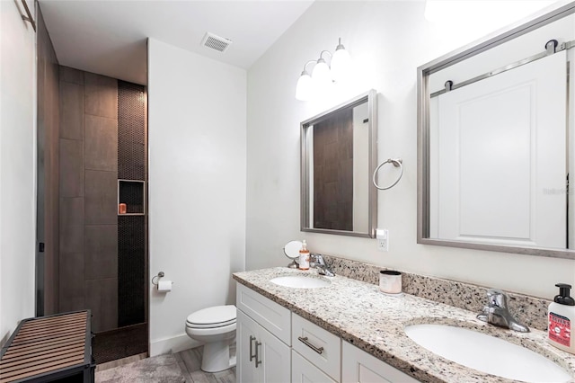 2709 Magdalina Dr Unit 101 102B, Punta Gorda, FL 33950 - full bathroom featuring a sink, visible vents, toilet, and double vanity