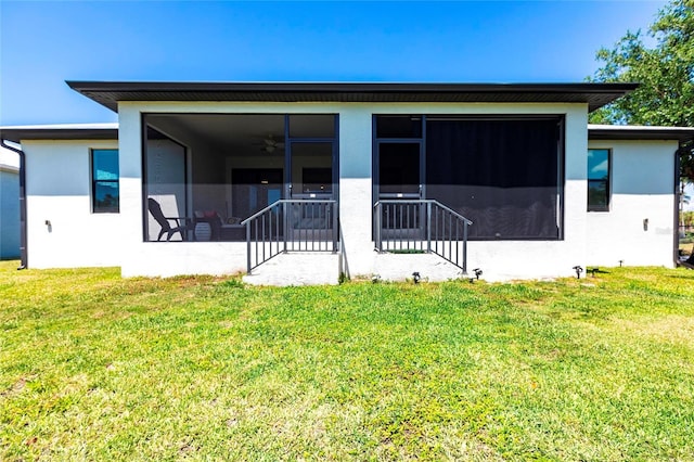 2709 Magdalina Dr Unit 101 102B, Punta Gorda, FL 33950 - rear view of property featuring a sunroom, stucco siding, and a lawn