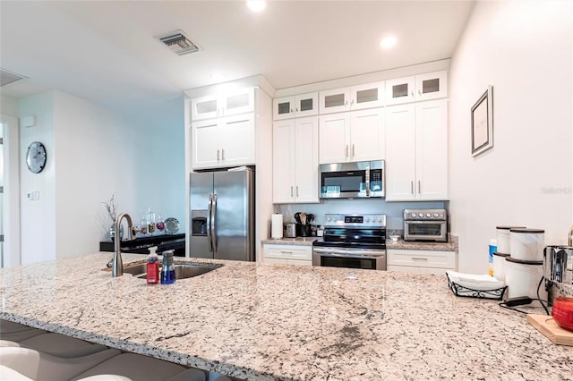 2709 Magdalina Dr Unit 101 102B, Punta Gorda, FL 33950 - kitchen featuring light stone countertops, visible vents, a sink, and appliances with stainless steel finishes