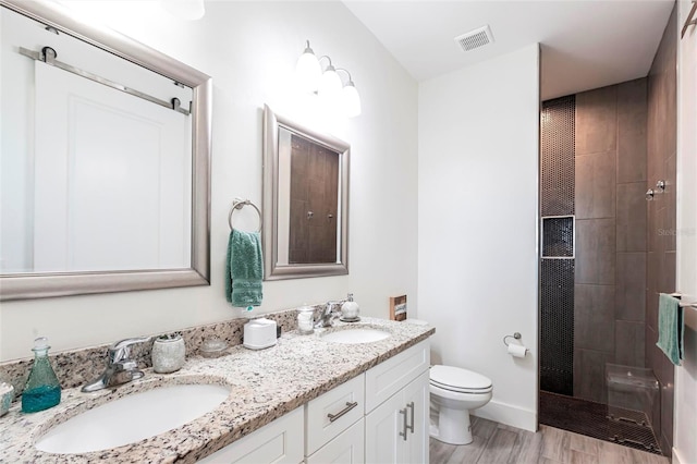 2709 Magdalina Dr Unit 101 102B, Punta Gorda, FL 33950 - bathroom with a sink, visible vents, toilet, and double vanity