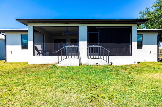 2709 Magdalina Dr Unit 101 102B, Punta Gorda, FL 33950 - rear view of house with a sunroom, a lawn, and stucco siding