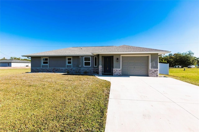 view of front of home with a garage and a front lawn