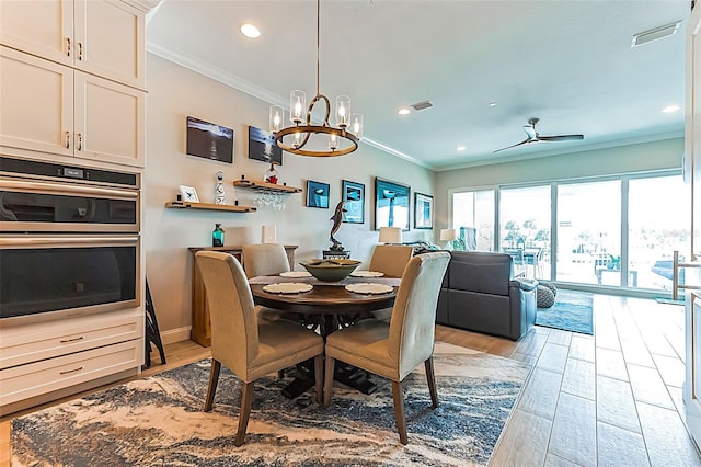 dining space with crown molding, ceiling fan with notable chandelier, and light hardwood / wood-style floors