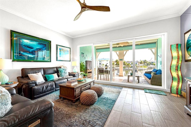 living room with ornamental molding, hardwood / wood-style floors, and ceiling fan