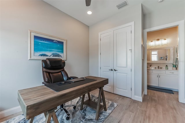 office space with a sink, visible vents, recessed lighting, baseboards, and light wood-style floors