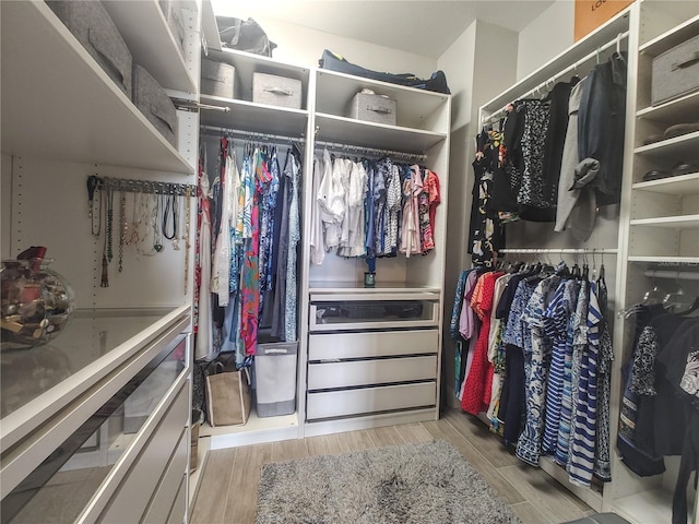 walk in closet featuring light wood-style flooring