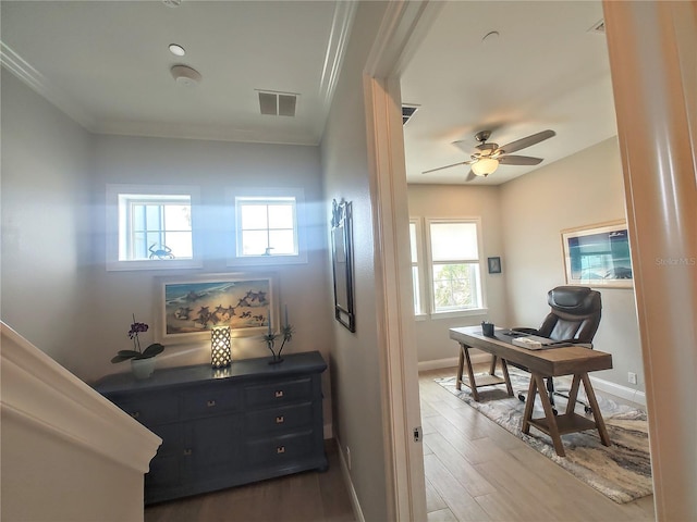 corridor with dark wood finished floors, visible vents, baseboards, and a healthy amount of sunlight