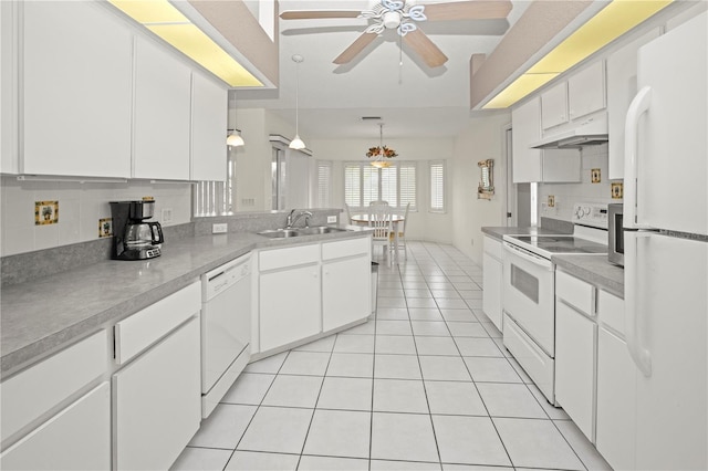 kitchen with light tile patterned floors, white appliances, sink, white cabinetry, and hanging light fixtures