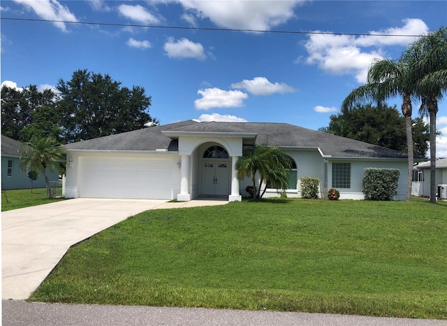 ranch-style home with a garage and a front lawn