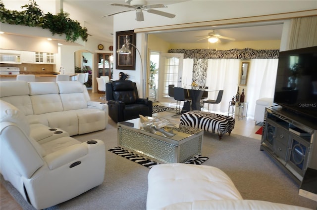 living room featuring light carpet and ceiling fan