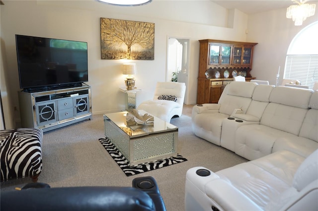 living room featuring carpet and a notable chandelier