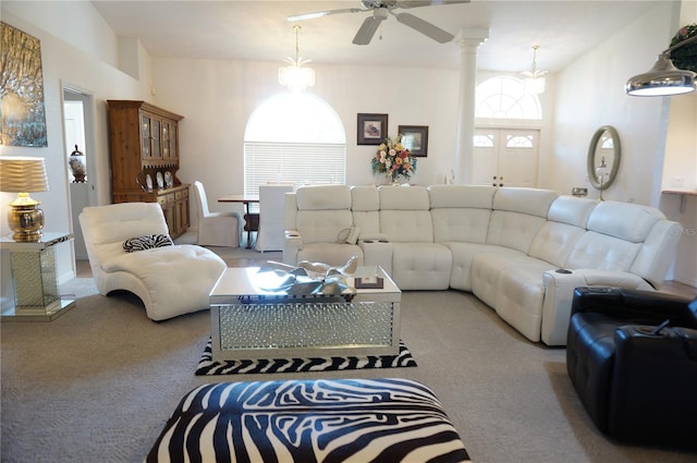 carpeted living room featuring ornate columns and ceiling fan