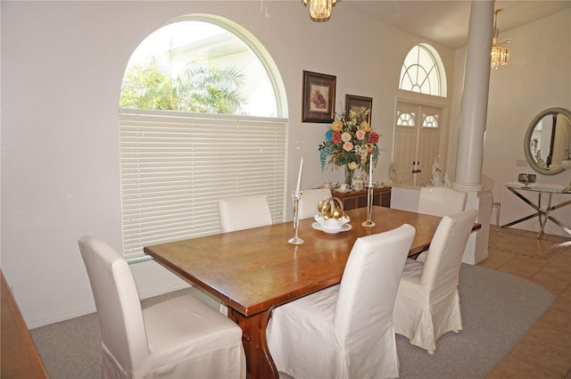 tiled dining space featuring decorative columns