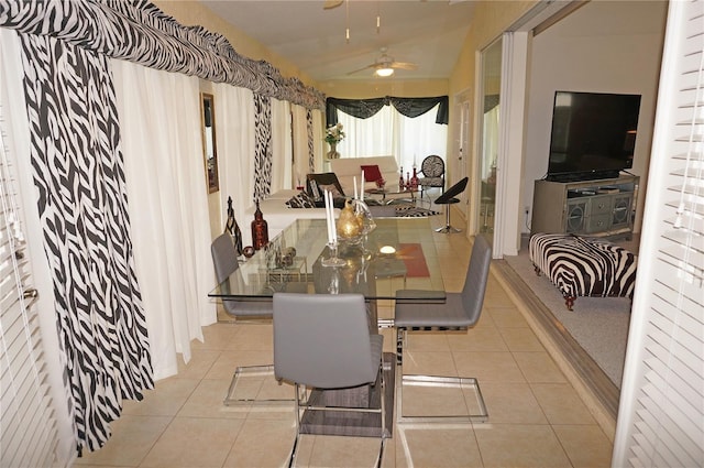 tiled dining room featuring ceiling fan and lofted ceiling