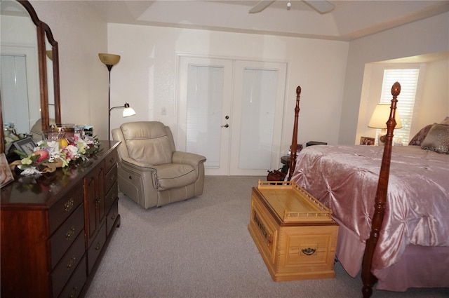 bedroom featuring light carpet, ceiling fan, and french doors