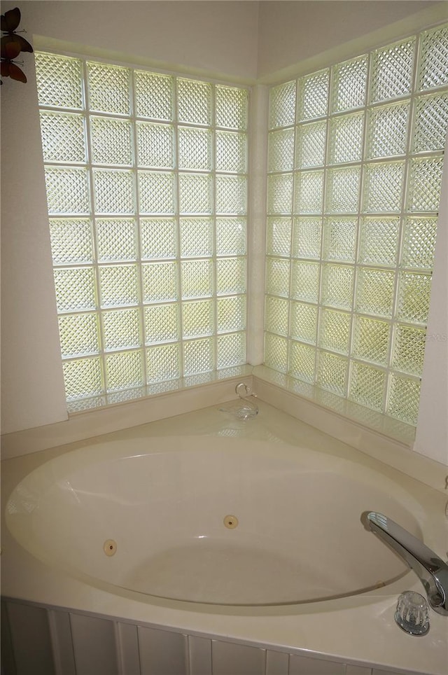 bathroom with a washtub and ceiling fan