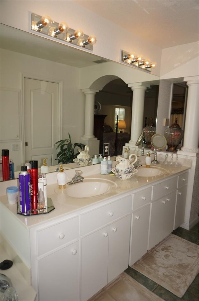 bathroom featuring vanity and ornate columns