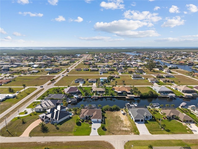 drone / aerial view featuring a water view and a residential view