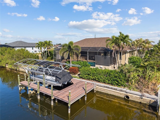 view of dock with a water view, glass enclosure, and boat lift