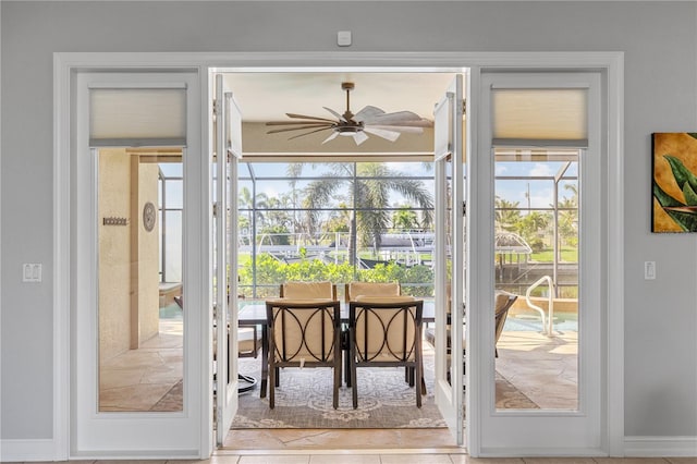 entryway with a sunroom, tile patterned flooring, and a ceiling fan