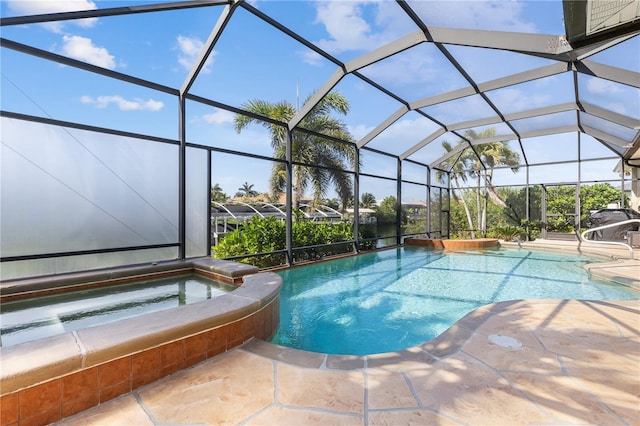 view of pool with a pool with connected hot tub, glass enclosure, and a patio