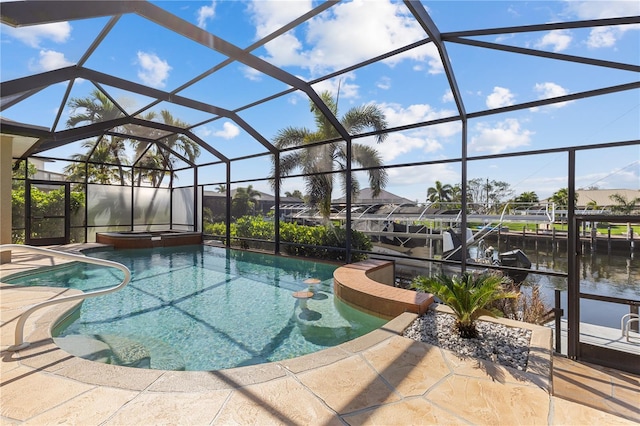 outdoor pool featuring an in ground hot tub, a patio, a water view, and a lanai