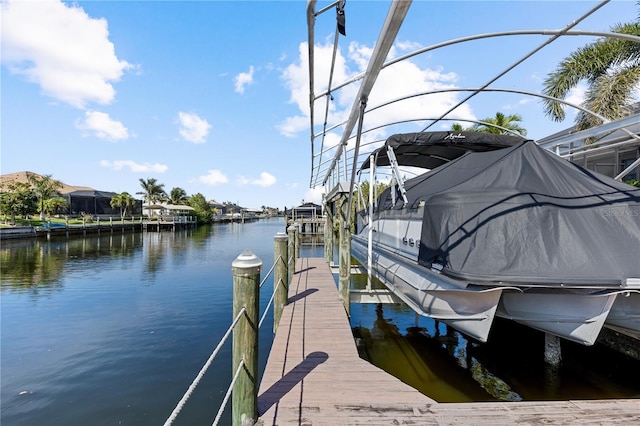 dock area with a water view and boat lift