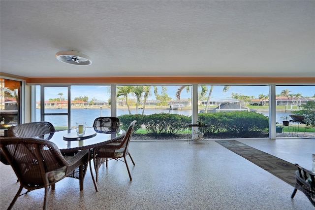 sunroom / solarium with a water view