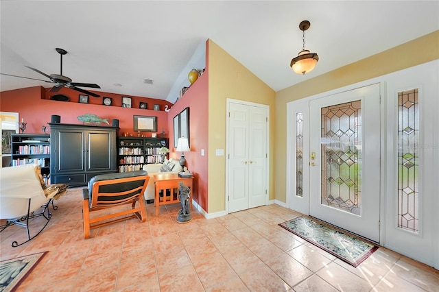 entrance foyer featuring lofted ceiling, light tile patterned floors, and ceiling fan