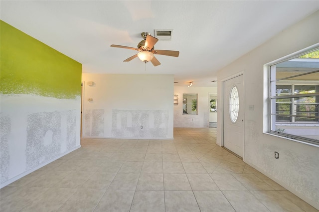 unfurnished room featuring ceiling fan and light tile patterned floors