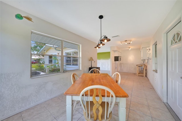 tiled dining area with a healthy amount of sunlight