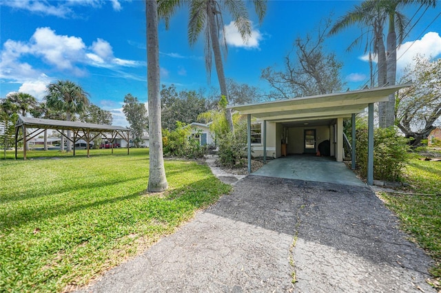 exterior space featuring a carport and a yard