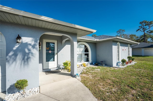 349 Grenada St, Port Charlotte, FL 33948 - view of exterior entry featuring a yard