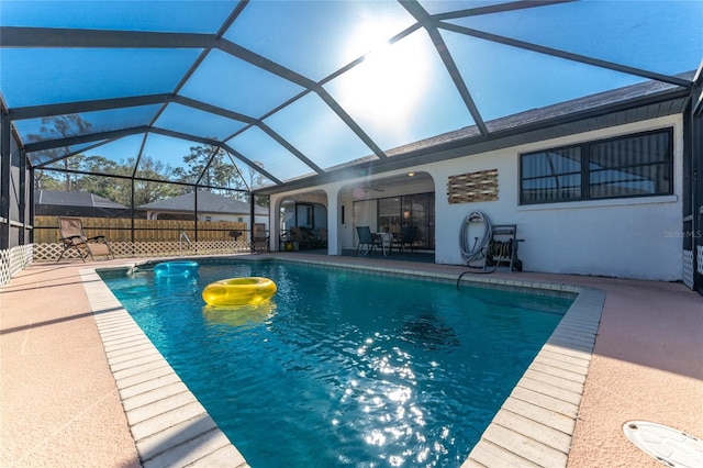 view of swimming pool featuring a lanai and a patio area