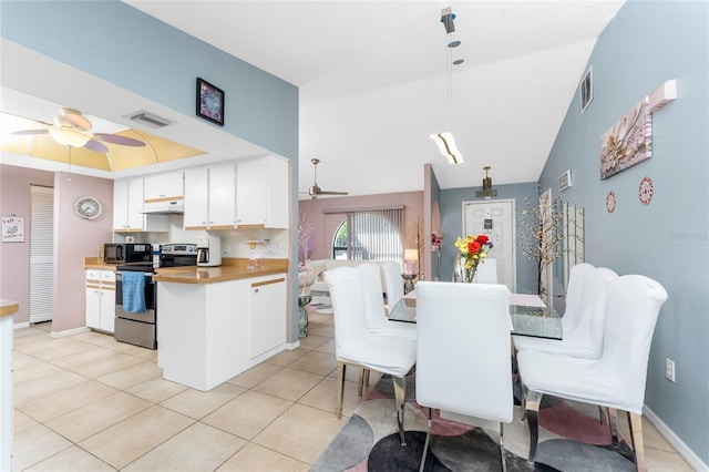 349 Grenada St, Port Charlotte, FL 33948 - dining area with light tile patterned floors, a tray ceiling, and ceiling fan