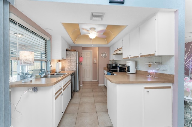 349 Grenada St, Port Charlotte, FL 33948 - kitchen with sink, stainless steel range with electric cooktop, a tray ceiling, dishwasher, and white cabinets