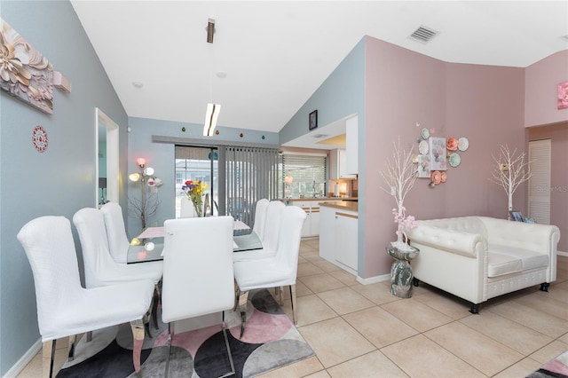 349 Grenada St, Port Charlotte, FL 33948 - dining space with vaulted ceiling and light tile patterned floors