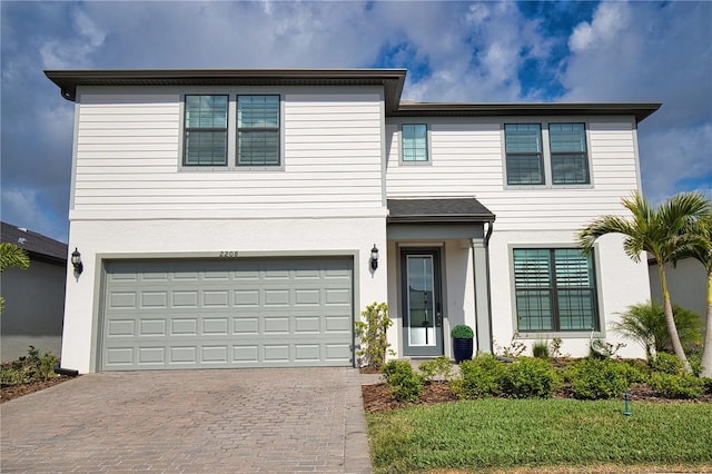 view of front of property featuring a garage and a front yard