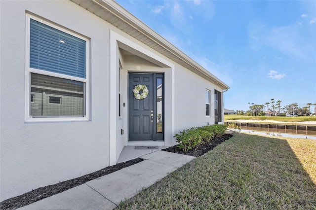 doorway to property with a yard