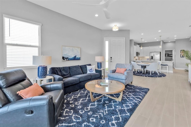 living room with ceiling fan and light hardwood / wood-style floors