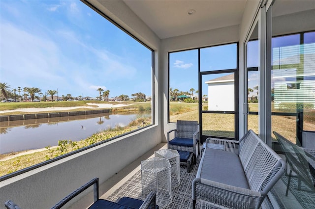 sunroom featuring a water view and a healthy amount of sunlight