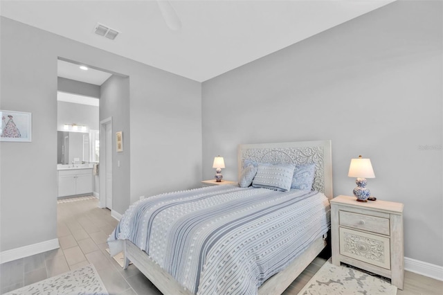 bedroom with light hardwood / wood-style floors, ceiling fan, and ensuite bathroom