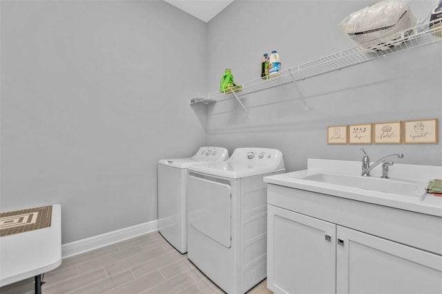 laundry room featuring cabinets, sink, and washing machine and dryer