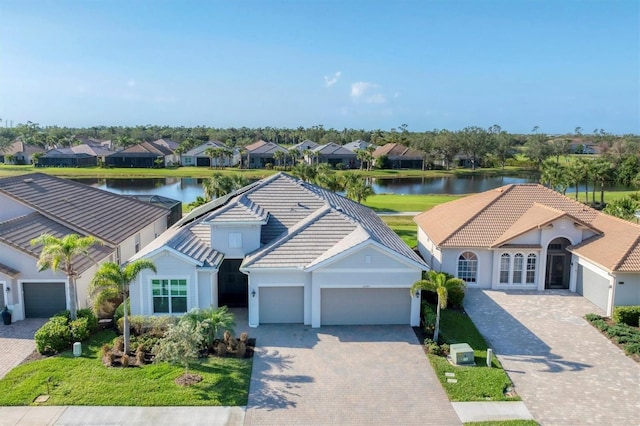 view of front of house with a garage and a water view